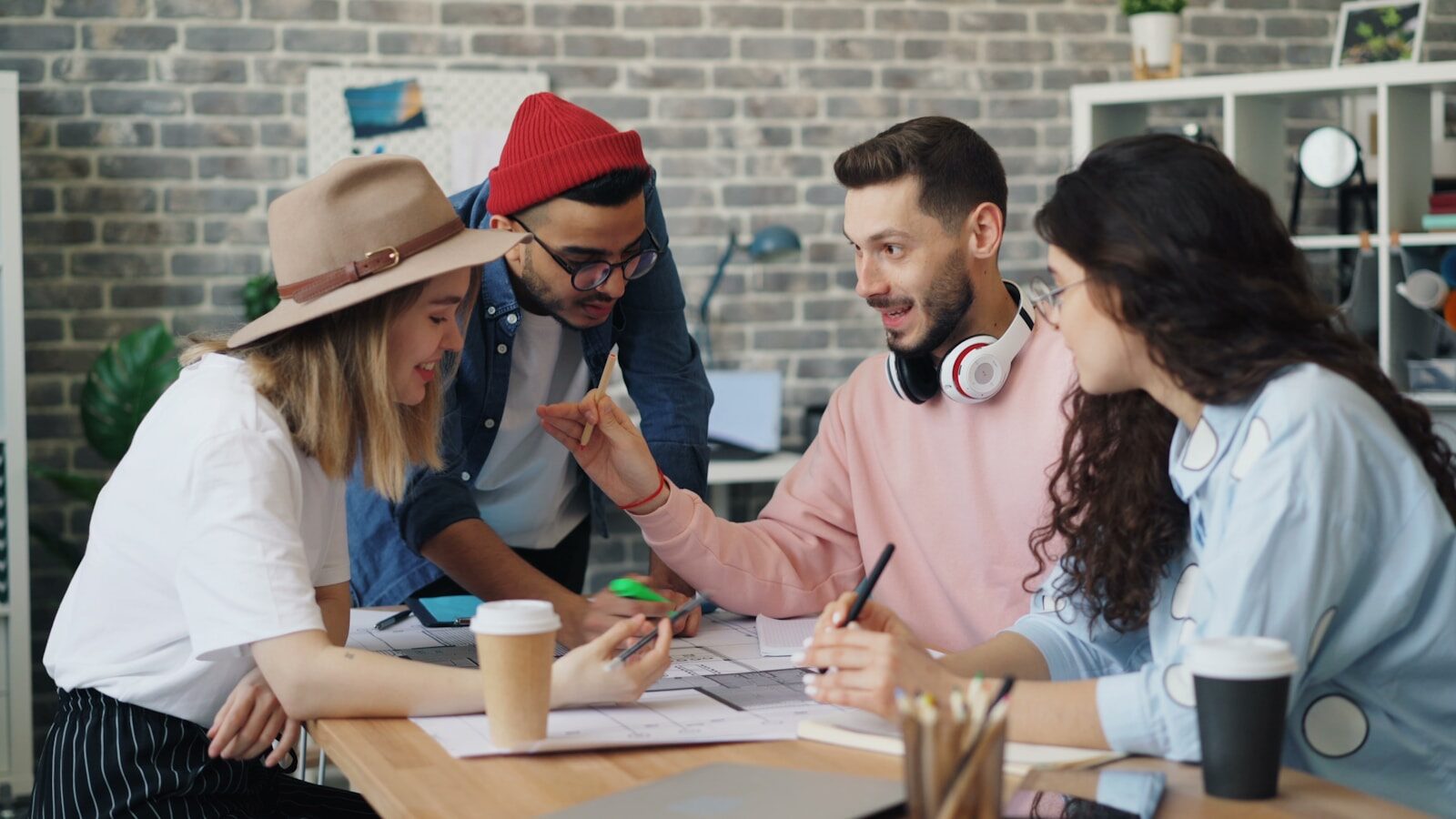 a group of people sitting around a wooden table